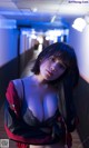 A woman in lingerie posing in a hallway.